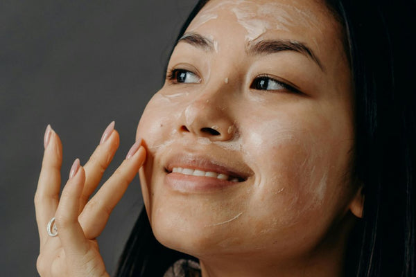 Woman applying moisturiser to her face
