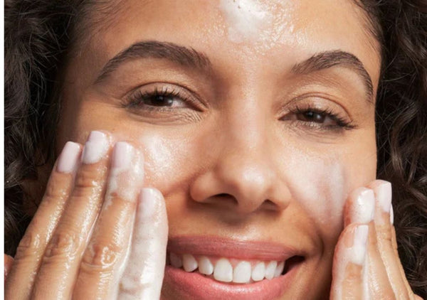 lady washing her face with glycolic acid face wash