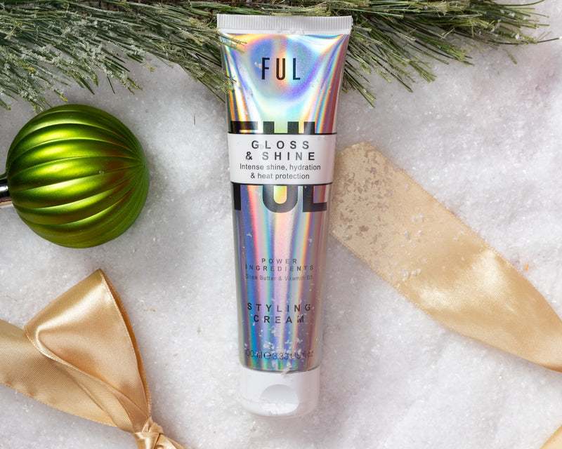 Tube of 'FUL' gloss and shine product with decorative ribbons and green ornaments on a white background