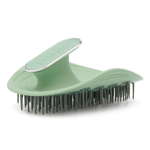 Green grooming brush with metal handle on a white background