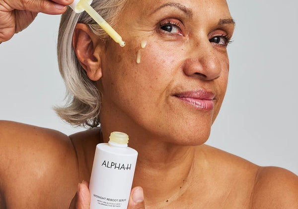 Mature lady applying Alpha-H Liquid Gold Midnight Reboot Serum