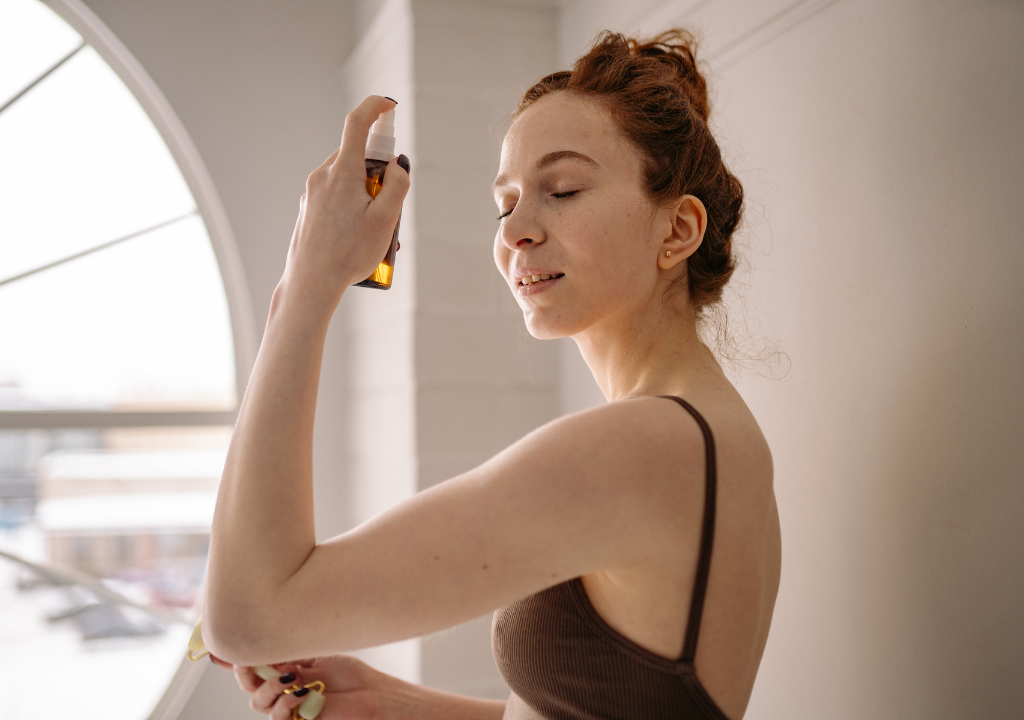 woman applying face mist