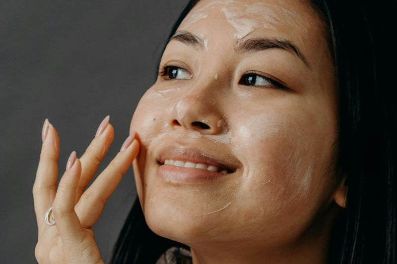 Woman applying moisturiser to her face