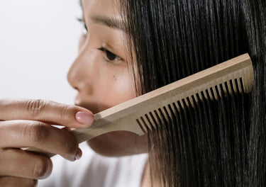 Lady brushing her healthy hair