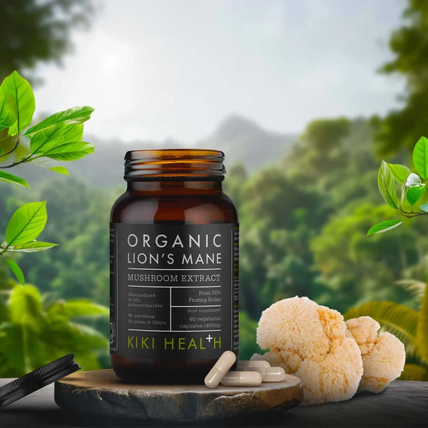 Bottle of Organic Lion's Mane Mushroom Extract by Kiki Health on a natural background with greenery.