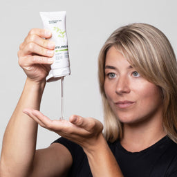 Woman demonstrating the use of a hair care product with a white background