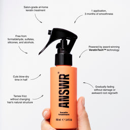 Hand holding an orange bottle labeled 'ANSWR' with text about its features on a white background