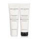 Two Percy & Reed hair care products on a white background