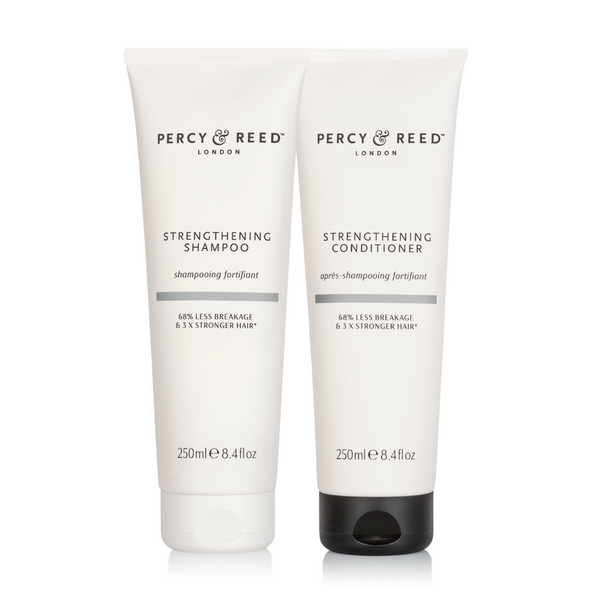 Two Percy & Reed hair care products on a white background