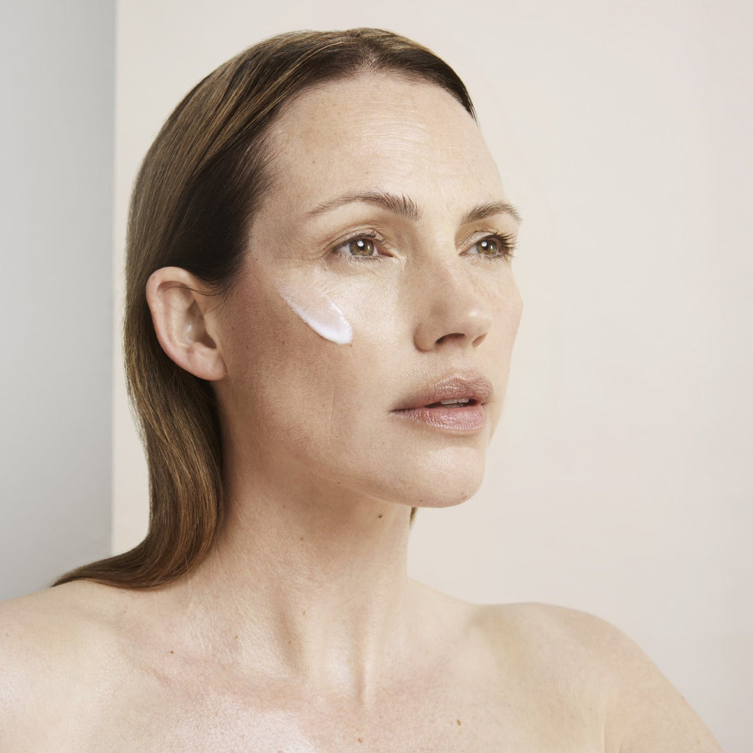 a women with cleanse applied to her cheek