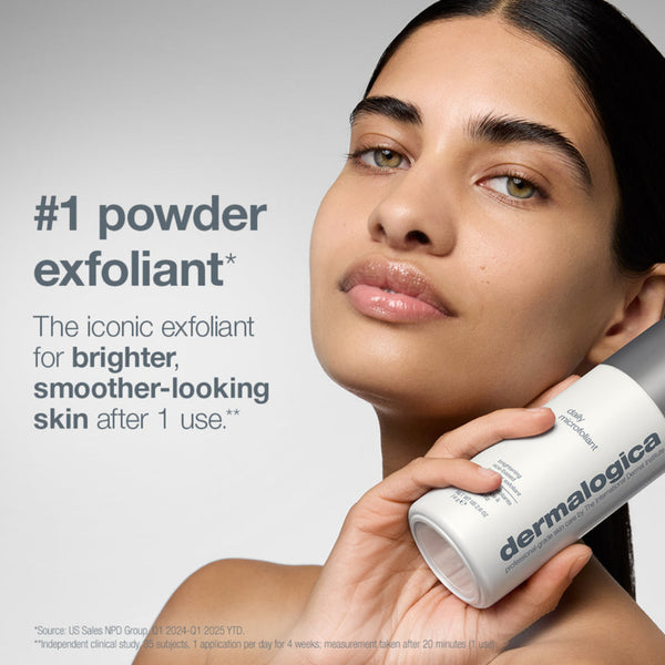 A woman holding a white and silver Dermalogica powder exfoliant bottle against a light gray background, with promotional text on the left.