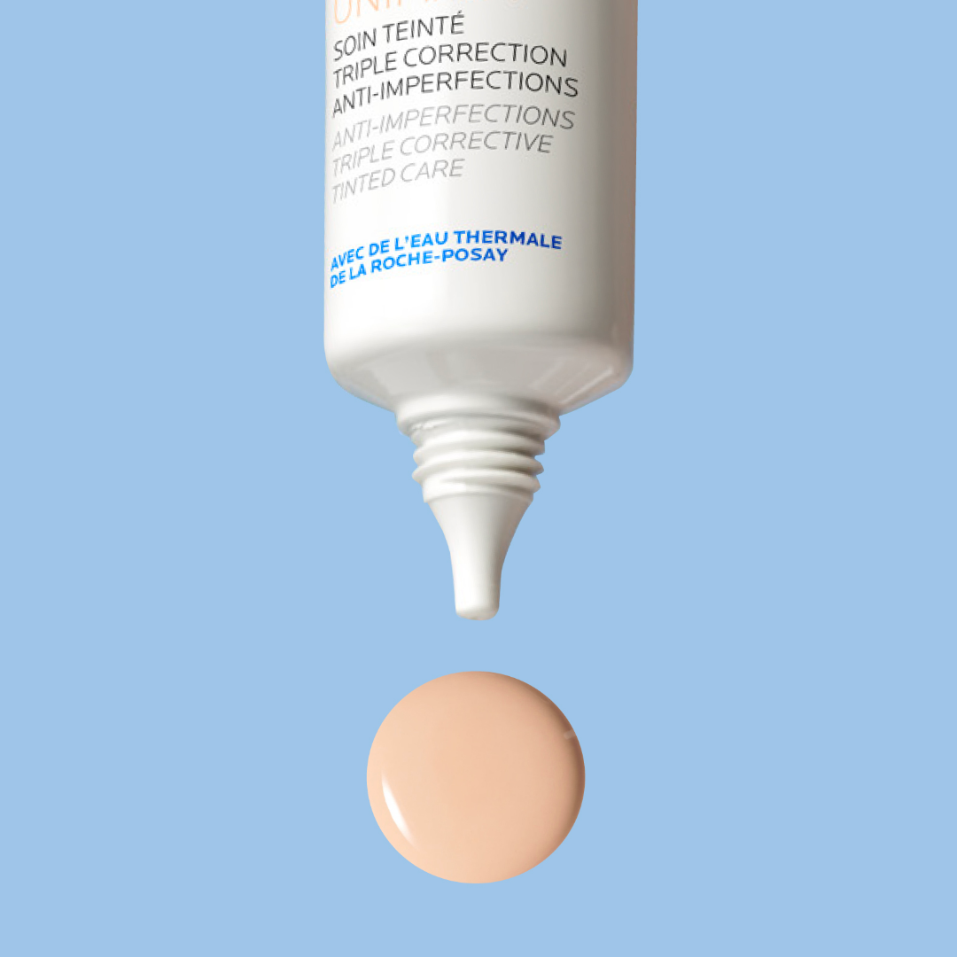 Skincare product with applicator and sample on a light blue background