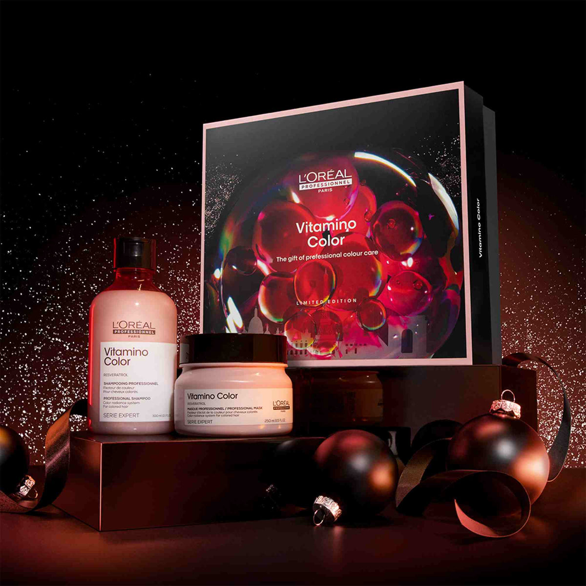 L'Oreal Vitamine Color hair care products with packaging on a dark background