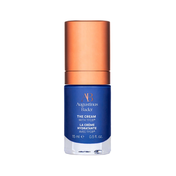 A bottle of Augustinus Bader The Cream with blue and copper packaging.
