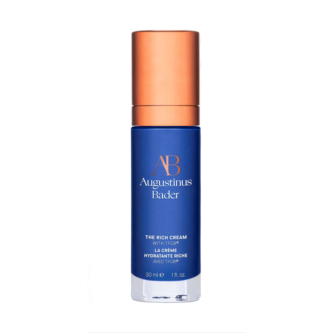 Blue skincare bottle with bronze cap on a white background
