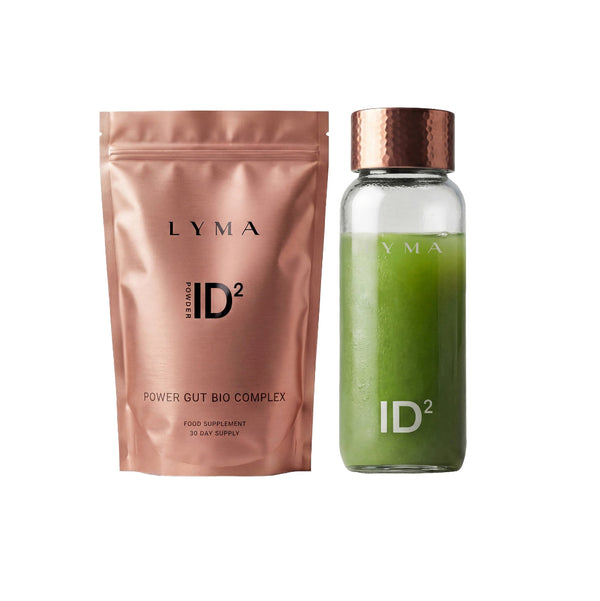 LYMA ID² Power Gut Bio Complex food supplement set, featuring a metallic rose gold pouch next to a clear glass bottle filled with green powder and topped with a copper-colored cap.