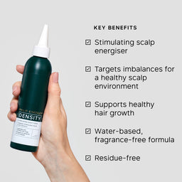 Hand holding a green scalp treatment bottle with key benefits listed on a gray background