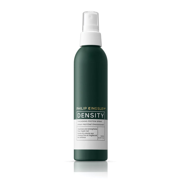 Green spray bottle with white cap labeled 'Philip Kingsley Density' on a white background