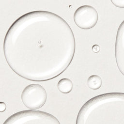 Close-up of clear bubbles on a light gray background