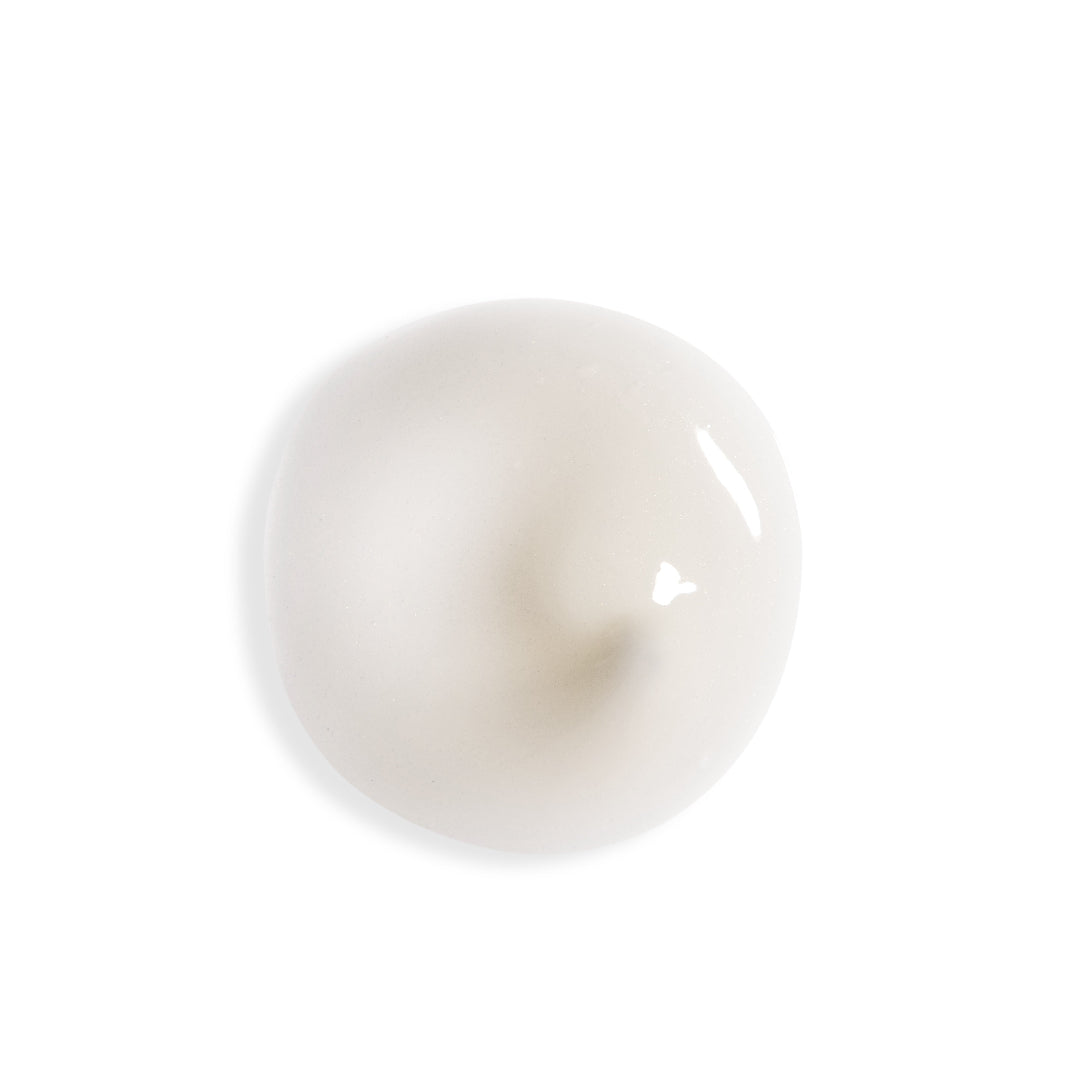 A glossy, smooth, off-white circular droplet or gel pool on a solid white background.