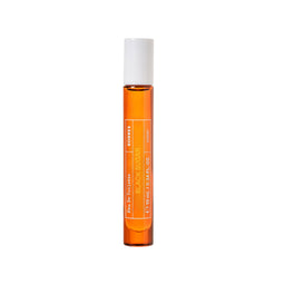 A small cylindrical rollerball bottle of Kores Black Sugar Eau De Toilette with amber liquid and a white cap, centered on a plain white background.