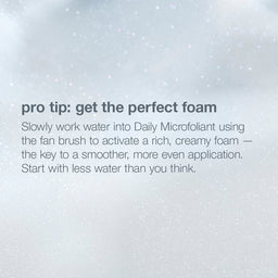 A text-based beauty tip graphic on a soft white and light gray background with faint speckled texture. The text reads: 'pro tip: get the perfect foam' followed by instructions about mixing water into Daily Microfoliant with a fan brush to activate rich, creamy foam.