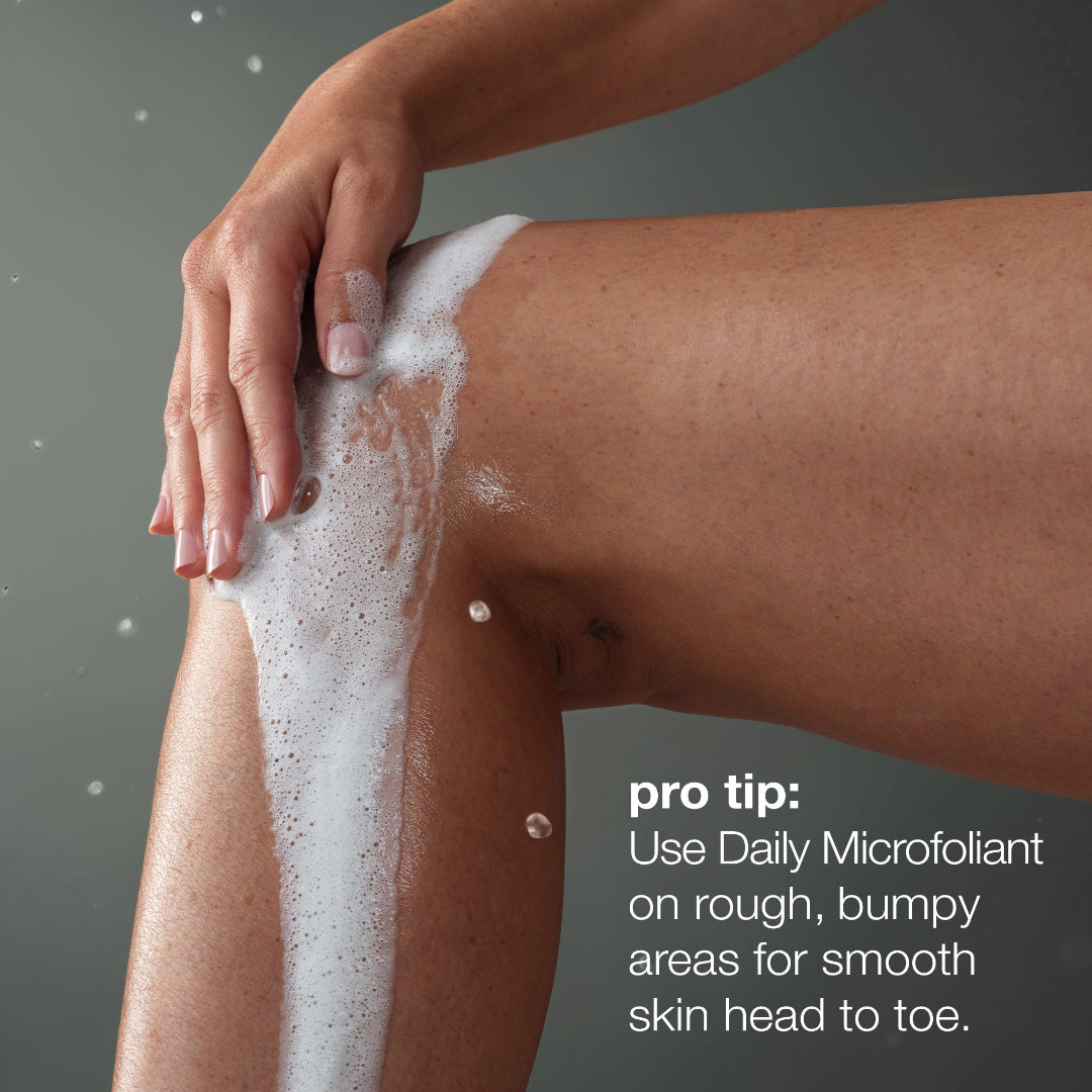 Person applying a Daily Microfoliant to their leg with a gray background