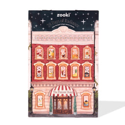 Zooki 28 Days of Radiance New Brave Longer Advent Calendar, designed as a vintage pink and red brick building with illustrated windows and a starry night sky header.