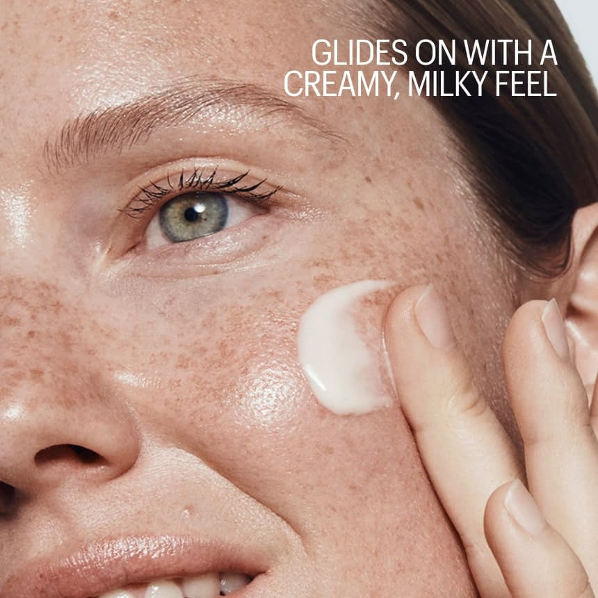 Person applying cream to their face with text about a creamy, milky feel