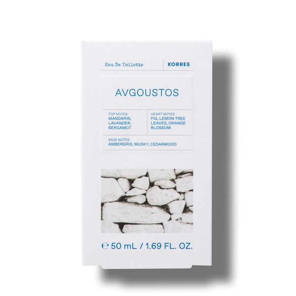 A white rectangular box of KORRES Avgoustos Eau De Toilette, featuring blue text and a black-and-white photograph of stacked stone walls near the bottom, set against a plain white background with a soft drop shadow.