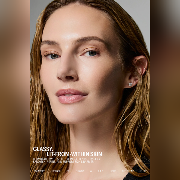 Close-up beauty portrait of a woman with wet light brown hair and subtle skin glow, wearing a small stud earring. Text at the bottom reads 'GLASSY, LIT-FROM-WITHIN SKIN' with skincare branding along the bottom edge.