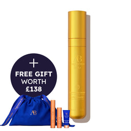 Gold serum bottle with blue drawstring bag and smaller bottles on a white background, featuring a free gift offer.
