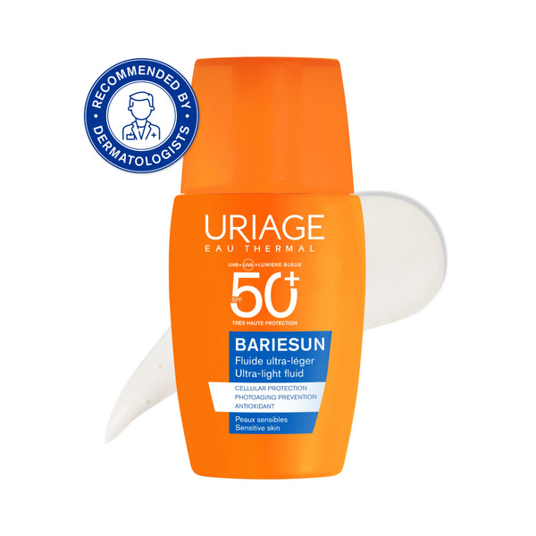A bottle of Uriage Eau Thermal Bariesun SPF 50+ sunscreen, featuring a bright orange cap and body with white and blue text, shown against a white background with a white smear behind it and a blue 'Recommended by Dermatologists' badge in the top left.