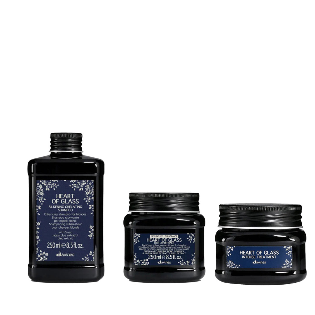 Three black hair care products with blue labels on a white background