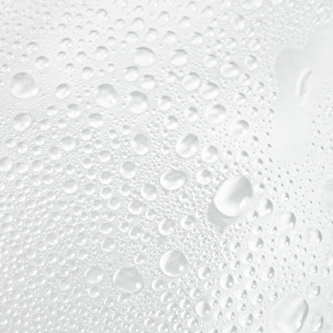 Close-up of water droplets on a white surface