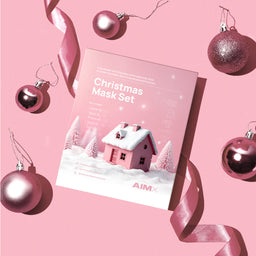 Christmas Mask Set packaging with festive decorations on a pink background