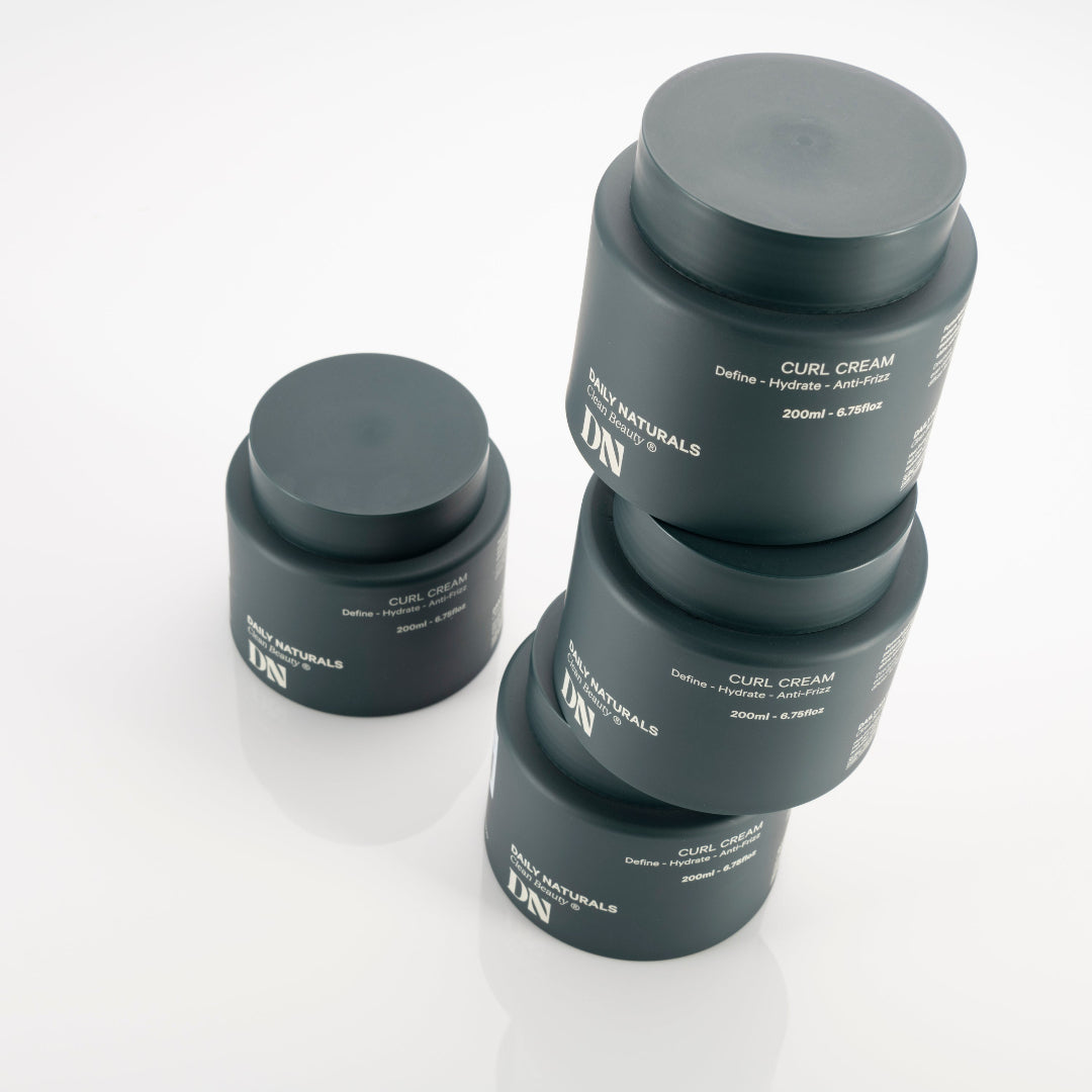 Three jars of Daily Naturals Curl Cream on a white background