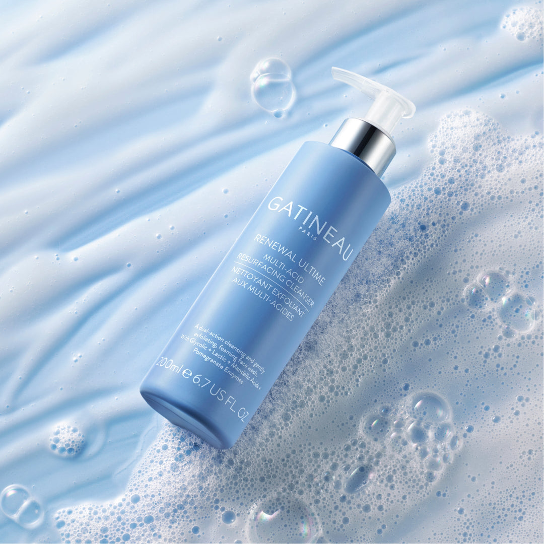 Gatineau skincare bottle on a textured blue background with bubbles
