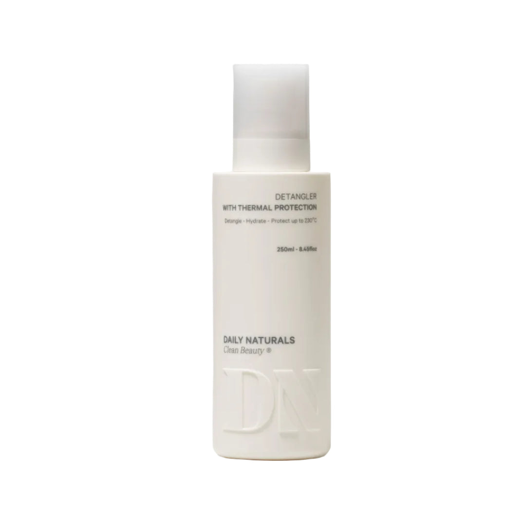 White bottle of Daily Naturals detangler on a light gray background