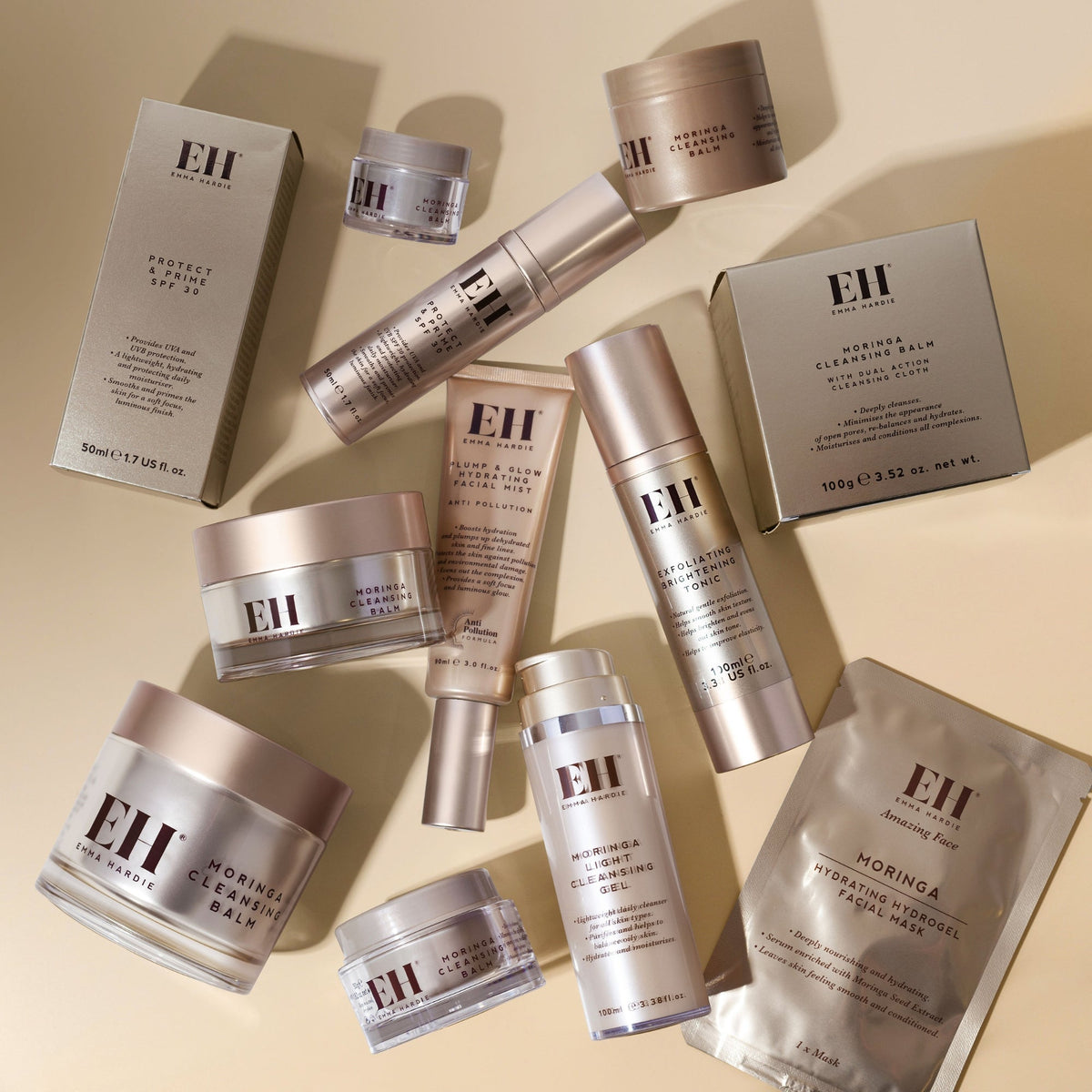 Collection of Emma Hardie skincare products on a beige background