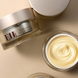 Emma Hardie Moringa Cleansing Balm jar with balm inside on a beige background