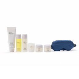 Collection of ESPA products including bottles, jars, and a sleep mask on a white background