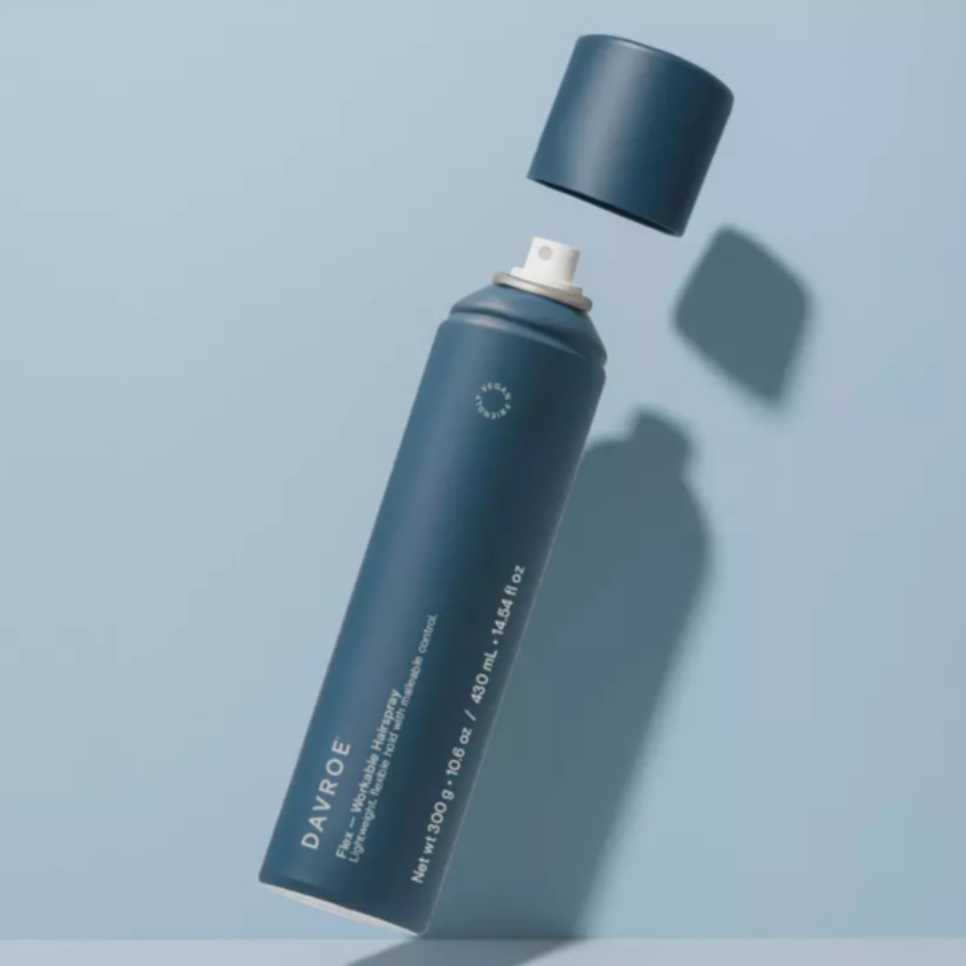 Blue spray bottle with 'DAVROE' branding on a light blue background