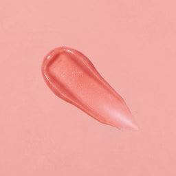 Pink lip gloss swatch on a pink background