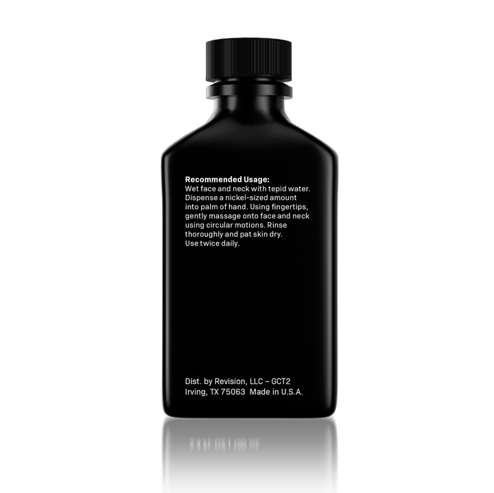 A black rectangular bottle with a ribbed screw cap, shown from the back on a white background with a soft reflection. White text on the bottle reads 'Recommended Usage' and includes 'Dist.