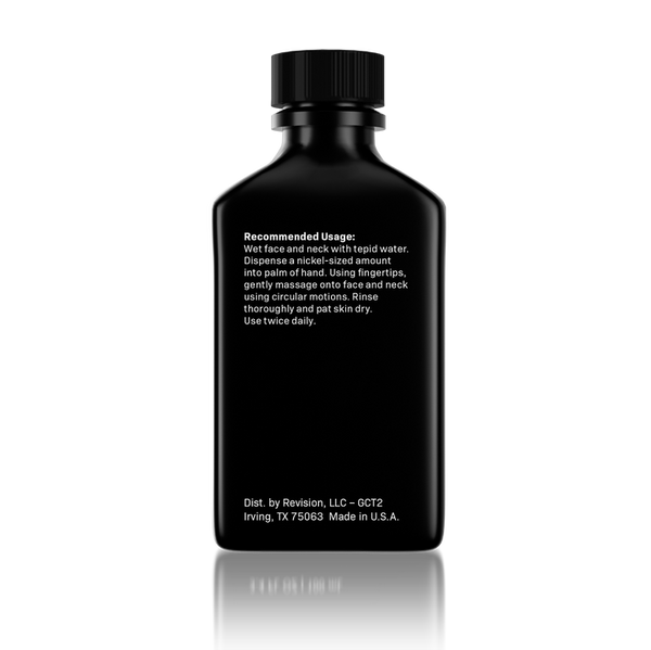 A black rectangular bottle with a ribbed screw cap, shown from the back on a white background with a soft reflection. White text on the bottle reads 'Recommended Usage' and includes 'Dist.