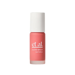 Lip balm with coral color and white cap on a light gray background