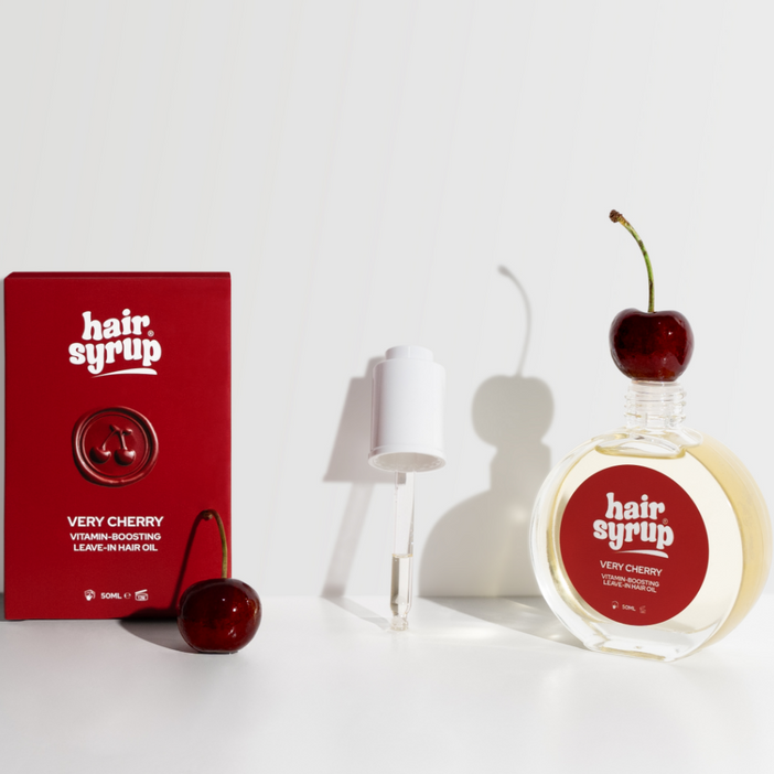 Hair syrup with cherry flavor packaging on a white background