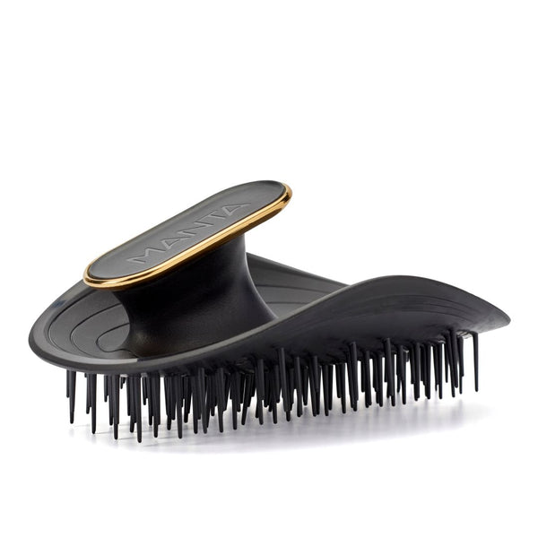 Black hairbrush with gold accents on a white background