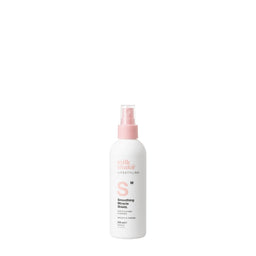 White spray bottle with pink nozzle on a white background